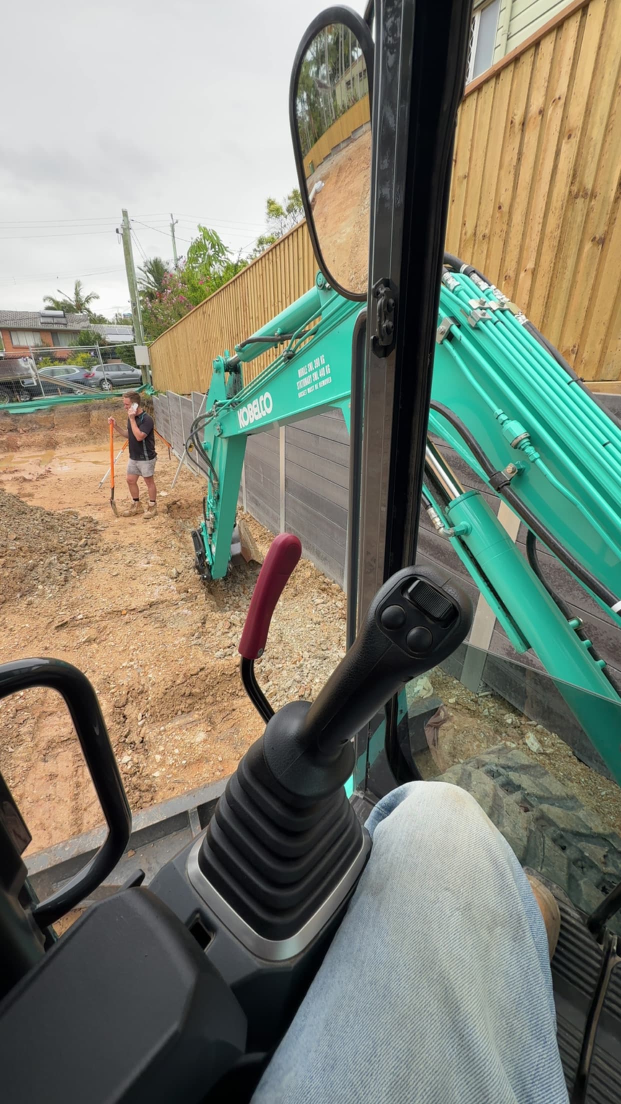 Excavator running service trenches across residential lots in the Scenic Rim