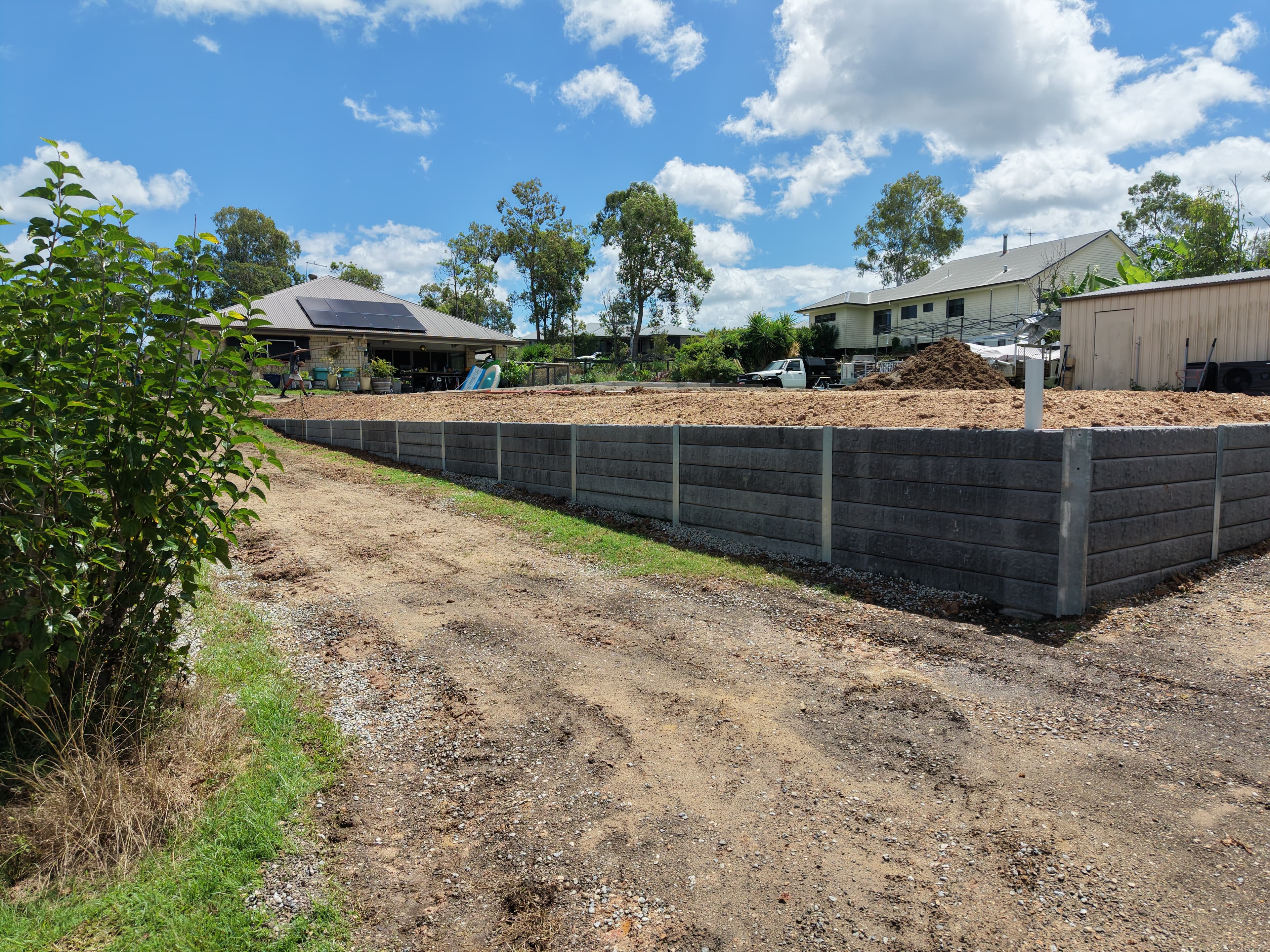 Finished concrete sleeper retaining wall and driveway access on a Gold Coast property
